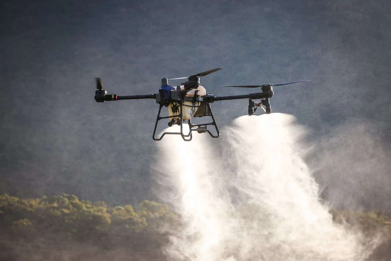 Agricultural drone spraying crops in the field