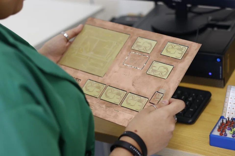 Electronics specialist examining a printed circuit board