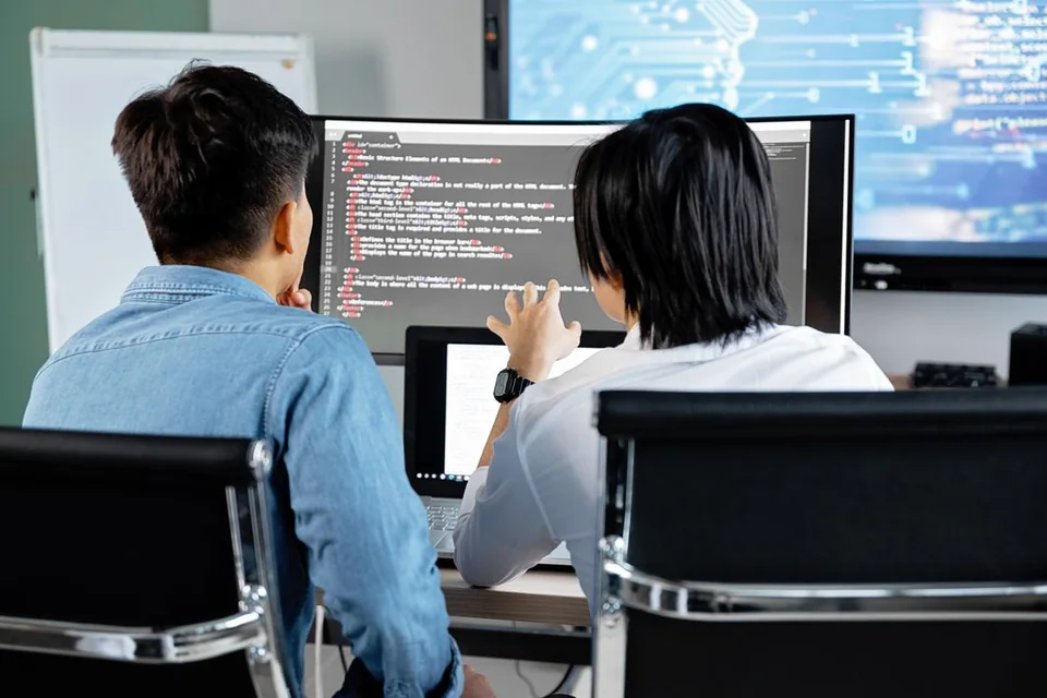 Developers reviewing software together at a workstation