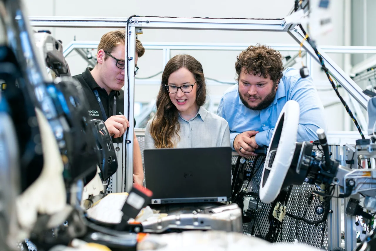 Engineers collaborating beside a vehicle test rig